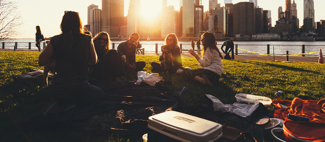 Friends sitting on a field and laughing